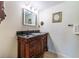 Bathroom vanity showcasing elegant wood craftsmanship, a granite countertop, and framed mirror at 5427 Springwood Blvd # 5427, Pinellas Park, FL 33782