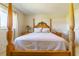 Bedroom featuring a four-poster bed, complemented by stylish bedside tables, offering a peaceful retreat at 5427 Springwood Blvd # 5427, Pinellas Park, FL 33782