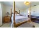 Spacious bedroom featuring a four-poster bed, stylish furnishings, and neutral tones at 5427 Springwood Blvd # 5427, Pinellas Park, FL 33782