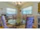 Bright breakfast nook with a glass-top table, four ornate chairs, and natural light at 5427 Springwood Blvd # 5427, Pinellas Park, FL 33782