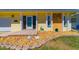 Charming yellow home featuring a stone facade, decorative rocks, and turtle lawn ornaments at 5427 Springwood Blvd # 5427, Pinellas Park, FL 33782