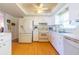 Bright kitchen featuring white cabinetry, wood floors and modern appliances, with plenty of space at 5427 Springwood Blvd # 5427, Pinellas Park, FL 33782