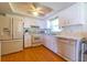 Functional kitchen featuring white cabinets, wood floors, modern appliances, and ample counter space at 5427 Springwood Blvd # 5427, Pinellas Park, FL 33782