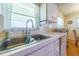 A bright kitchen featuring a stainless sink, tile backsplash, and natural light at 5427 Springwood Blvd # 5427, Pinellas Park, FL 33782