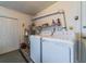 Laundry room with appliances, storage shelves, and convenient access to the outdoors at 5427 Springwood Blvd # 5427, Pinellas Park, FL 33782