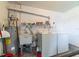 Laundry room with washer, dryer, utility sink, and a water heater for convenience at 5427 Springwood Blvd # 5427, Pinellas Park, FL 33782
