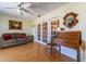 Cozy living room with French doors, a comfortable sofa, and vintage-style wooden writing desk at 5427 Springwood Blvd # 5427, Pinellas Park, FL 33782