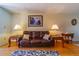 Comfortable living room featuring a leather sofa, wood floors, and accent lighting at 5427 Springwood Blvd # 5427, Pinellas Park, FL 33782