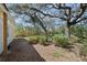 Landscaped backyard featuring a mix of grass and mulch under a large shade tree at 6327 Emerson S Ave, St Petersburg, FL 33707