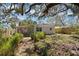 Backyard with seating, wooden fence, shade trees and landscaping at 6327 Emerson S Ave, St Petersburg, FL 33707