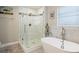 Bright bathroom featuring a glass shower, freestanding tub, marble accents and modern fixtures at 6327 Emerson S Ave, St Petersburg, FL 33707