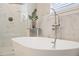 Bright bathroom featuring a glass shower, freestanding tub, marble accents and modern fixtures at 6327 Emerson S Ave, St Petersburg, FL 33707