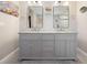 Bright bathroom features a double vanity with grey cabinets, white countertops and modern fixtures at 6327 Emerson S Ave, St Petersburg, FL 33707
