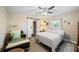 Bright bedroom with a sliding barn door, plush chair, and hardwood floors at 6327 Emerson S Ave, St Petersburg, FL 33707