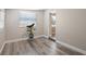 Bedroom features wood-look flooring, a window, and neutral paint at 6327 Emerson S Ave, St Petersburg, FL 33707