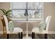 Bright dining nook near a window with a modern white table and decor at 6327 Emerson S Ave, St Petersburg, FL 33707