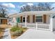 Charming single-story home featuring a manicured lawn, concrete walkway, and a delightful picket fence at 6327 Emerson S Ave, St Petersburg, FL 33707