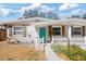 Charming single-story home featuring a manicured lawn, concrete walkway, and a delightful picket fence at 6327 Emerson S Ave, St Petersburg, FL 33707
