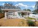Charming single-story home featuring a manicured lawn, concrete walkway, and a delightful picket fence at 6327 Emerson S Ave, St Petersburg, FL 33707