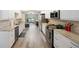 Modern kitchen featuring white cabinets, stainless steel appliances, and luxury vinyl flooring at 6327 Emerson S Ave, St Petersburg, FL 33707
