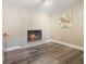 Cozy living room featuring wood-look flooring, a fireplace with a tile surround at 6327 Emerson S Ave, St Petersburg, FL 33707