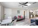 Open living area with hardwood floors, modern decor, natural light, and connection to kitchen at 6327 Emerson S Ave, St Petersburg, FL 33707