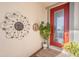Charming front entry with a red door, decorative accents, and a welcoming plant arrangement at 7515 37Th E Ave, Palmetto, FL 34221