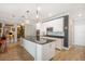 Bright kitchen featuring white cabinetry, granite countertops and modern chandeliers at 7515 37Th E Ave, Palmetto, FL 34221