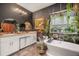 Bathroom features stylish décor, plants, bathtub and dual sinks at 7515 37Th E Ave, Palmetto, FL 34221