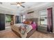 Main bedroom featuring tray ceilings, a sitting area, and ensuite bath with plants at 7515 37Th E Ave, Palmetto, FL 34221