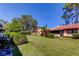 Expansive backyard featuring lush green lawn, mature landscaping, and serene outdoor space for relaxation at 9769 86Th Ave # 9769, Seminole, FL 33777