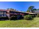 Exterior view of the backyard featuring a patio, green lawn, and well-maintained landscaping at 9769 86Th Ave # 9769, Seminole, FL 33777