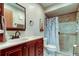 Beautiful bathroom with dark wood cabinetry, a framed mirror, and a modern shower at 9769 86Th Ave # 9769, Seminole, FL 33777
