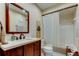 Well lit bathroom with a dark wood vanity, white countertop, and a shower with white tile at 9769 86Th Ave # 9769, Seminole, FL 33777