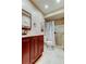 Well-lit bathroom with dark wood cabinetry, white counters, and a glass-enclosed shower at 9769 86Th Ave # 9769, Seminole, FL 33777
