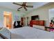 Inviting bedroom featuring a queen bed, dresser with TV, and ensuite bathroom access at 9769 86Th Ave # 9769, Seminole, FL 33777