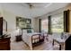 Bright bedroom featuring a large bed, a decorative painting, and a stylish accent chair at 9769 86Th Ave # 9769, Seminole, FL 33777