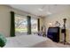 Bright bedroom featuring two windows, hardwood floors, decorative furniture, and contemporary furnishings at 9769 86Th Ave # 9769, Seminole, FL 33777