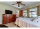Tranquil bedroom with ample natural light, spacious dresser, and comfortable queen bed at 9769 86Th Ave # 9769, Seminole, FL 33777