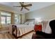 Comfortable bedroom showcasing a queen-size bed, natural lighting and an adjacent nightstand at 9769 86Th Ave # 9769, Seminole, FL 33777