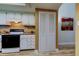Well-lit kitchen with white cabinets, granite countertops, and modern appliances at 9769 86Th Ave # 9769, Seminole, FL 33777