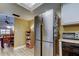 Open kitchen design, showcasing the stainless steel refrigerator and adjacent dining area at 9769 86Th Ave # 9769, Seminole, FL 33777
