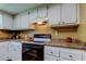 Bright kitchen with white cabinets, granite countertops, and modern appliances, perfect for cooking at 9769 86Th Ave # 9769, Seminole, FL 33777