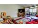 Relaxing living room with a large TV and access to the outdoor patio at 9769 86Th Ave # 9769, Seminole, FL 33777