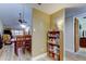 Hallway view of a well-stocked pantry and dining area with natural lighting at 9769 86Th Ave # 9769, Seminole, FL 33777