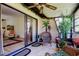 Cozy screened patio with tile flooring, ceiling fan, and comfortable wicker furniture at 9769 86Th Ave # 9769, Seminole, FL 33777