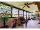 Sunroom featuring tile flooring, many windows, comfortable seating, and numerous potted plants at 9769 86Th Ave # 9769, Seminole, FL 33777