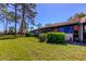 Rear of the house showing large window expanse, manicured shrubs and grassy lawn at 9769 86Th Ave # 9769, Seminole, FL 33777