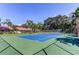 Outdoor community tennis court with lush greenery and trees surrounding the area at 9769 86Th Ave # 9769, Seminole, FL 33777