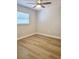 Cozy bedroom with light wood flooring, a window for natural light, and neutral wall paint at 10320 White Cedar St, Port Richey, FL 34668